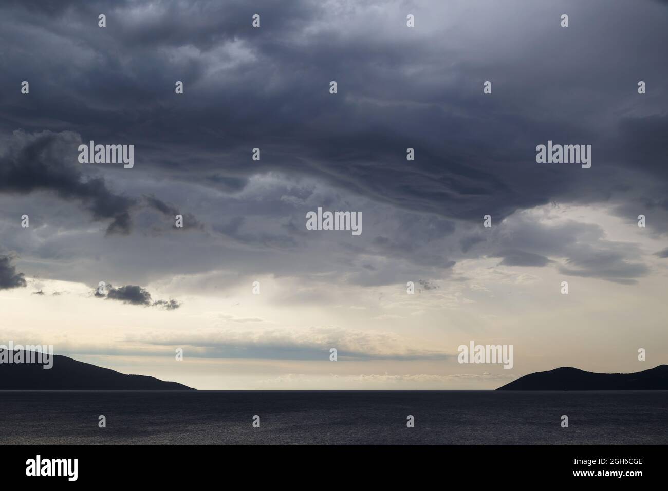 Ciel sombre et spectaculaire avec nuages orageux au-dessus de la mer. Banque D'Images