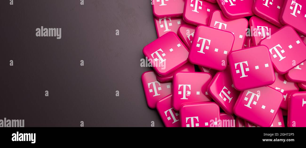 Logos du fournisseur allemand de télécommunications Deutsche Telekom sur un tas sur une table. Copier l'espace. Format de bannière Web. Banque D'Images