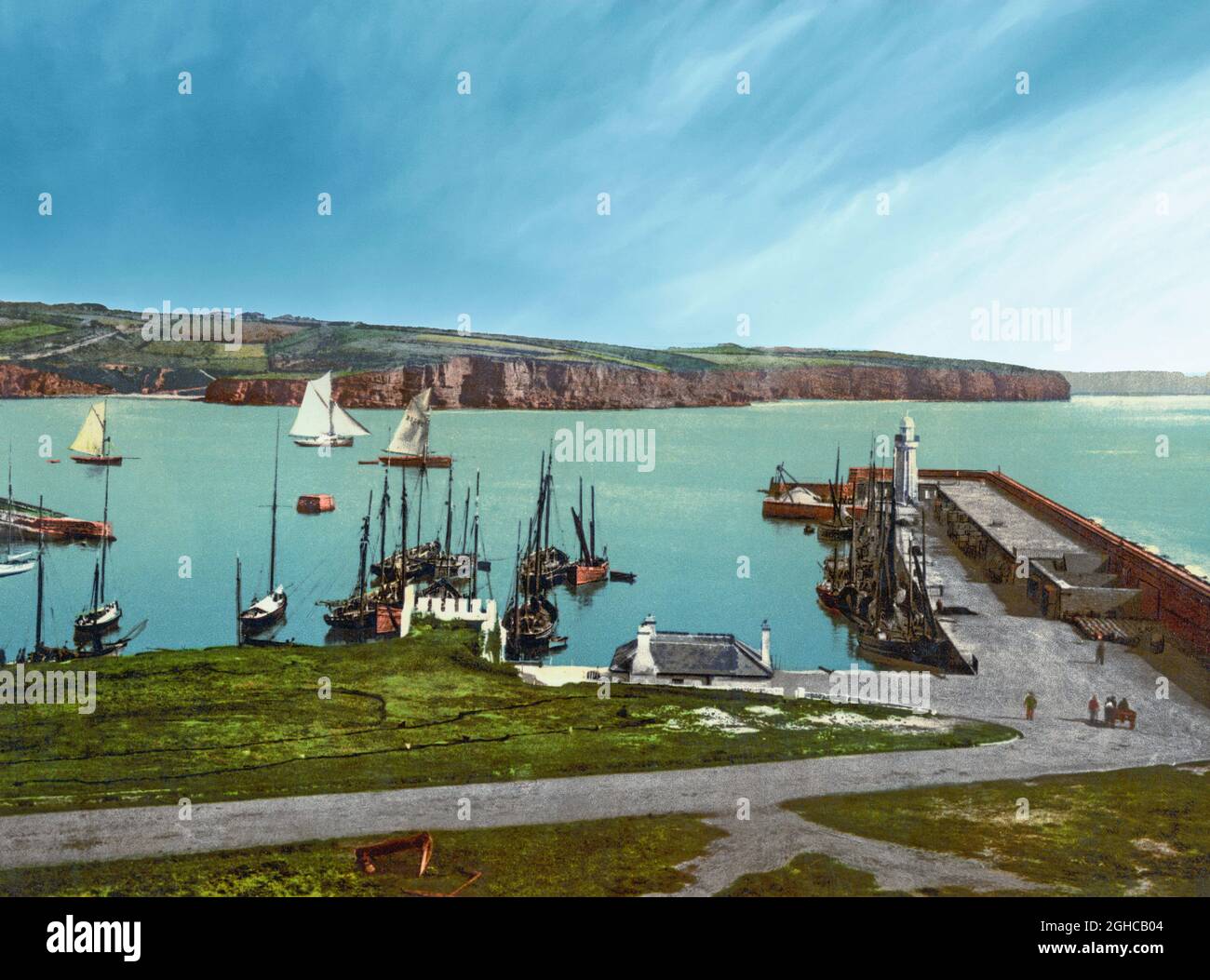 Une vue du début du XXe siècle sur le port de Dunmore East, un village touristique et de pêche populaire dans le comté de Waterford, en Irlande. Situé à l'ouest du port de Waterford, sur la côte sud-est de l'Irlande, il se trouve à l'intérieur de la baronnie de Gaultier (Gáll Tír – « terre d'étrangers » en irlandais), une référence à l'afflux de colons viking et normands dans la région. Banque D'Images