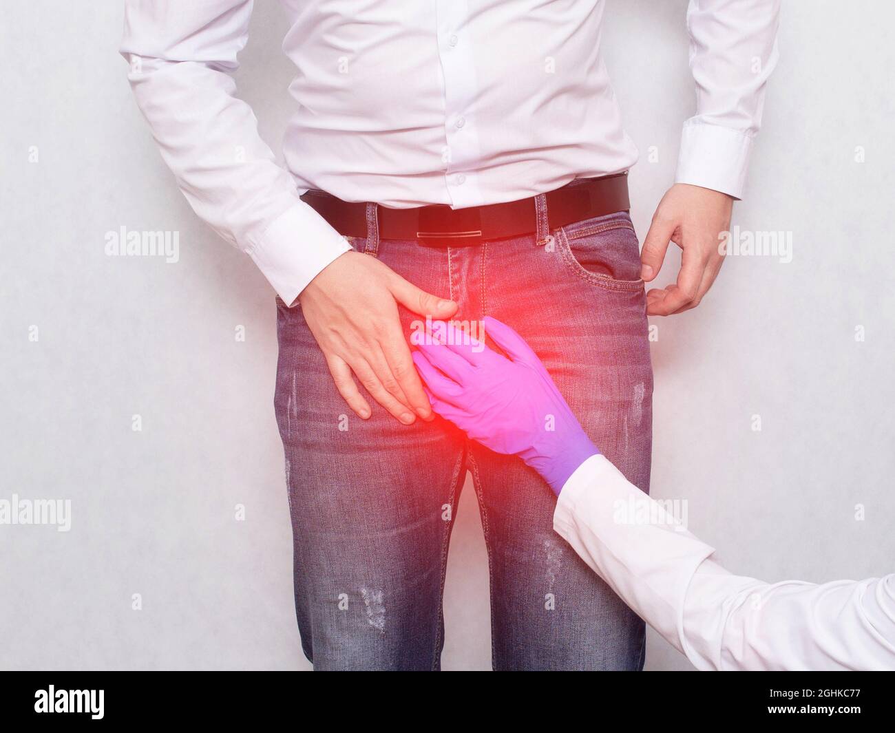 Un médecin dans un gant médical tient sur la zone de l'aine d'un patient masculin. Concept des maladies génito-urinaires, varicocèle et prostatite chez les hommes, hypoth Banque D'Images