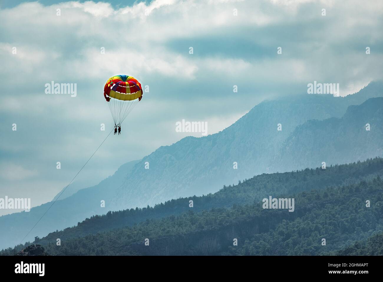 silhouette de couple heureux en parachute ascensionnel sur la mer tropicale. Les actions extrêmes de l'été Banque D'Images