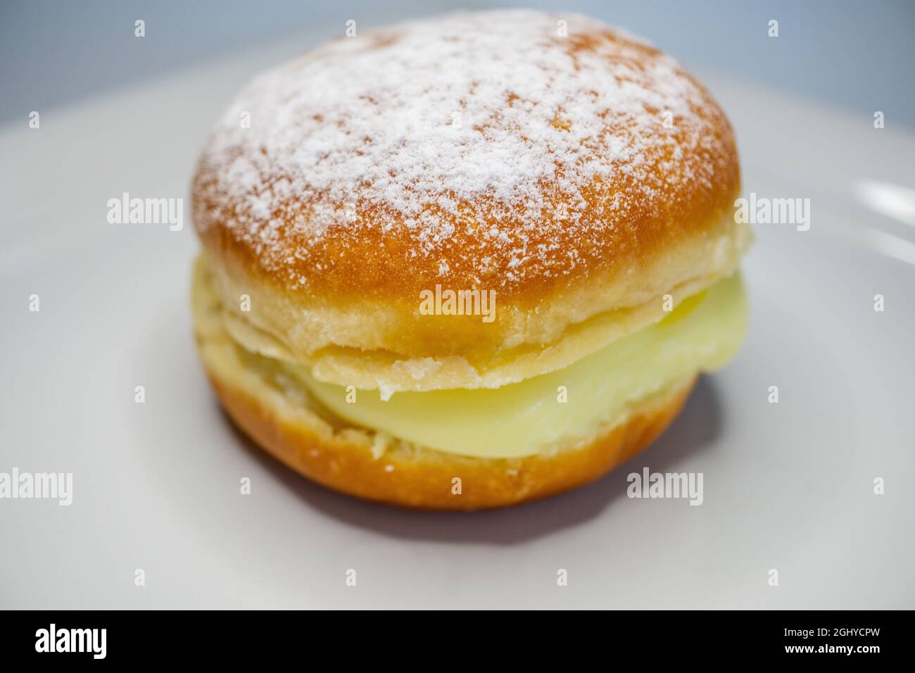 gros plan de la pâte berlinère sur une assiette blanche - plat de pâtisserie allemand avec garniture à la crème vanille Banque D'Images
