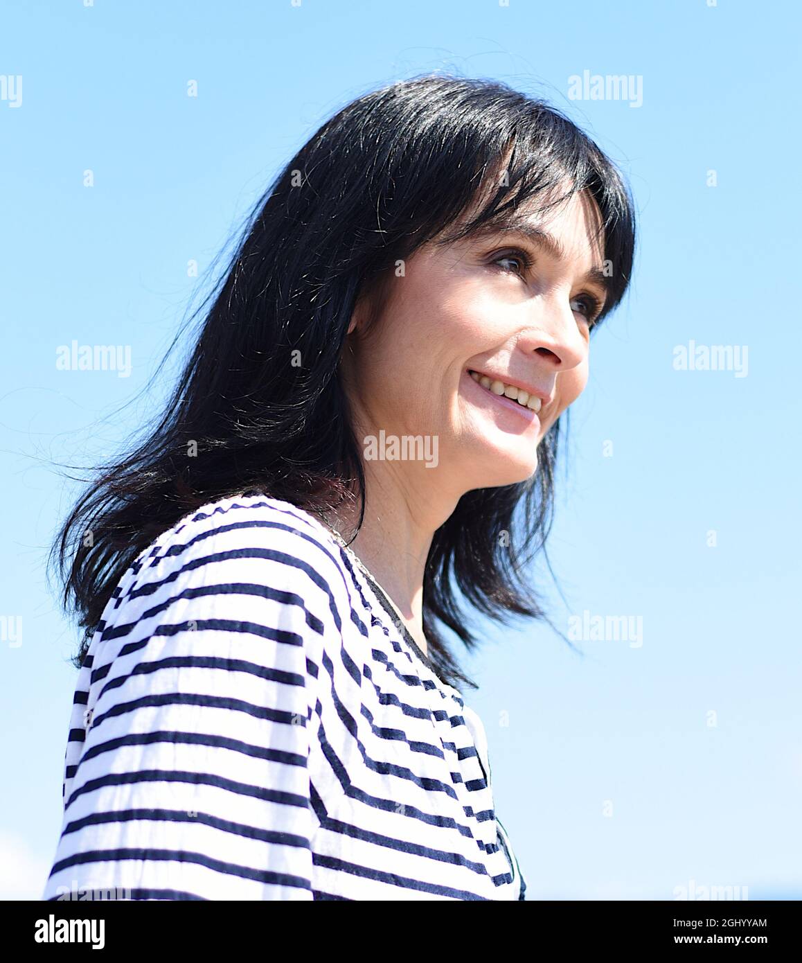 Femme russe de 45 ans riant et se tenant contre le ciel bleu Banque D'Images