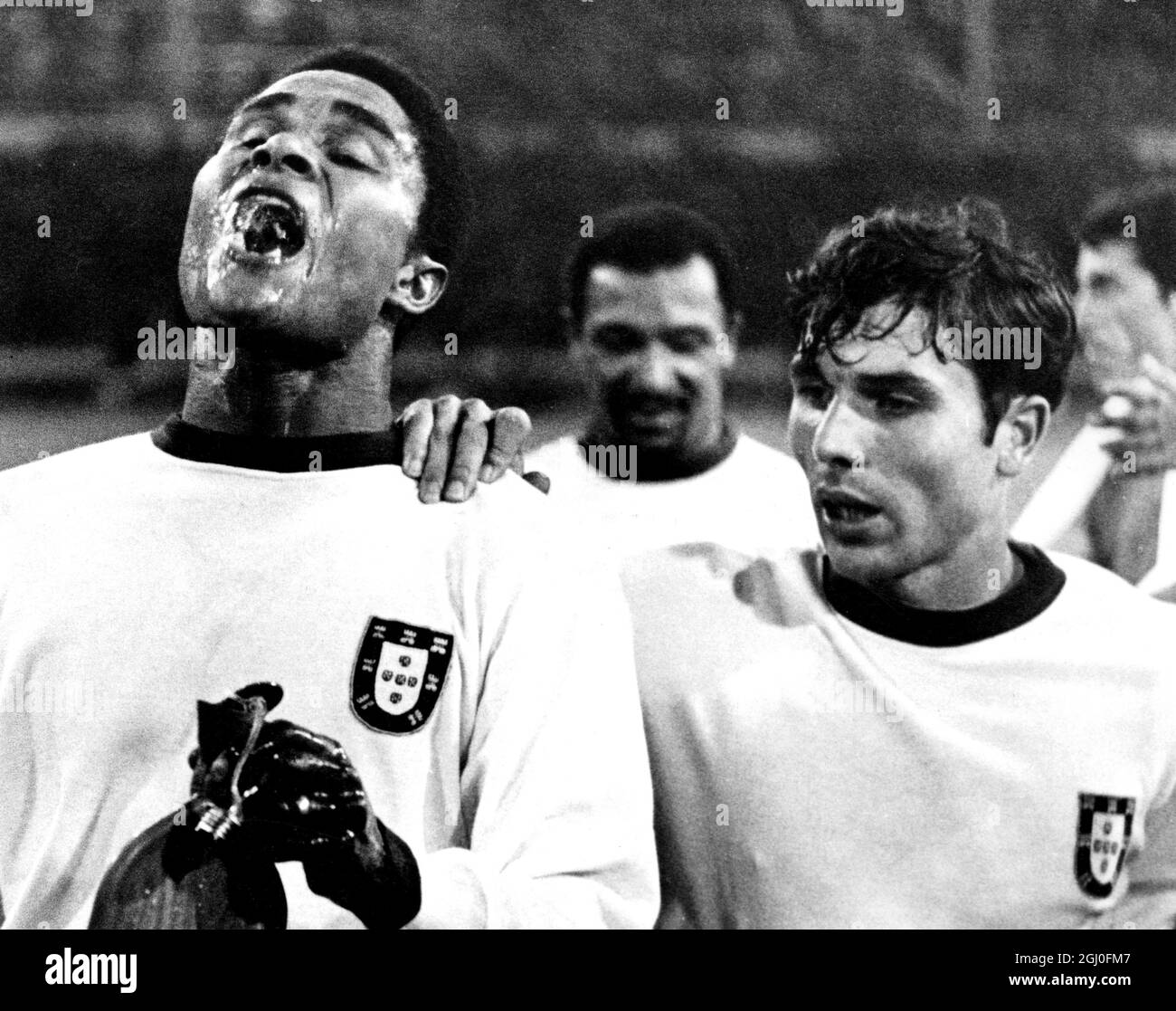 Match de la 3ème place de la coupe du monde Portugal / Russie Eusebio prend un verre en se promenant sur le terrain de Wembley avec ses copains d'équipe après que le Portugal a remporté la troisième place en finale de la coupe du monde avec une victoire de 2-1 sur la Russie. Également sur la photo sont Portugal joueurs Simoes, et (arrière-plan centre) Coluna. Banque D'Images
