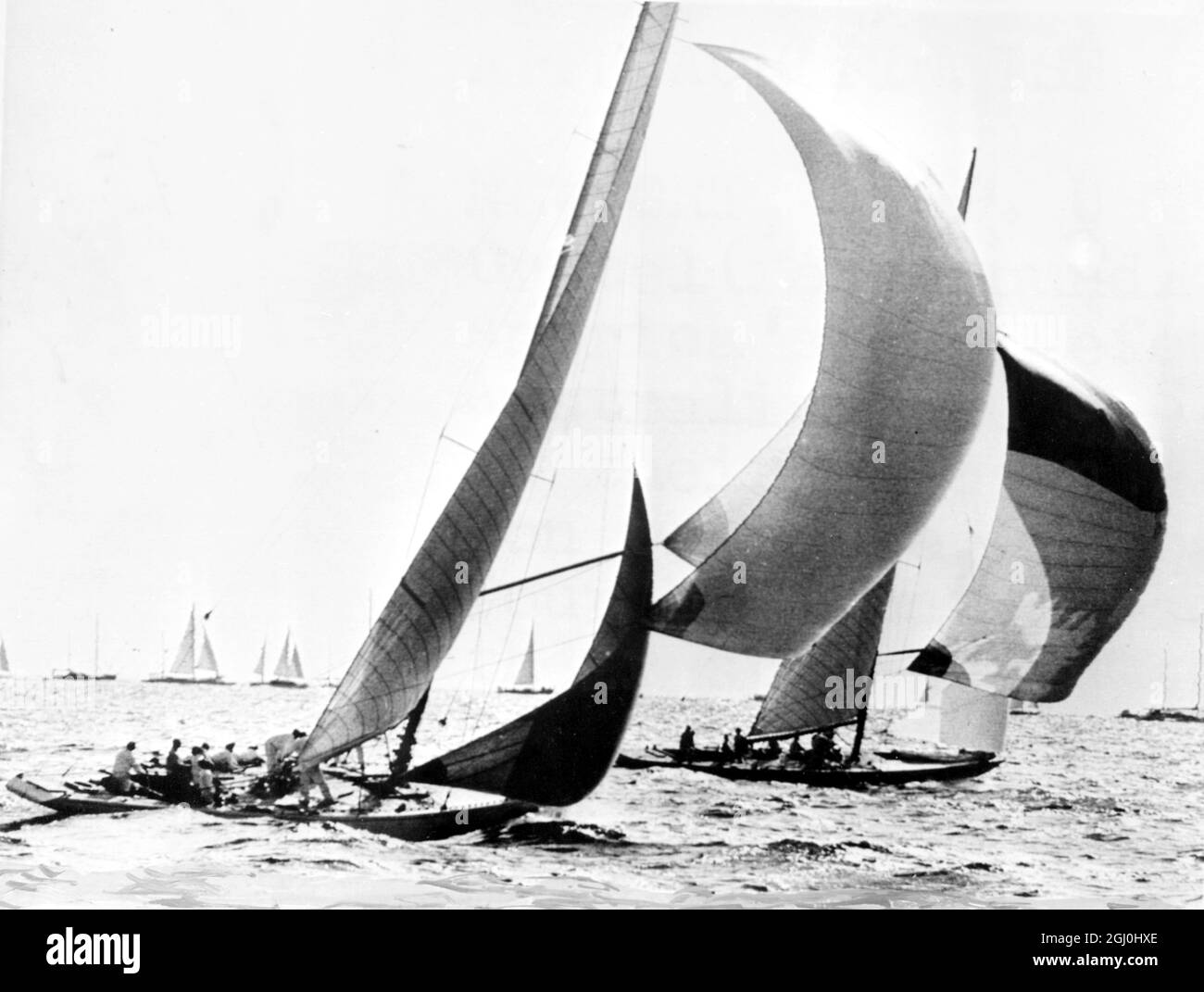 Newport, R.I. USA: Le challenger australien Gretel (premier plan) tente de rattraper le défenseur de la coupe américaine Wreatherly (arrière) comme les bateaux australiens et américains près de la ligne d'arrivée dans leur course le 22 septembre 1962. Weatherly a gagné la course, pour obtenir trois à un de tête dans les quatre meilleures séries sur sept. Les deux yachts ont leurs spinnakers à l'arrivée. 30 janvier 1963 Banque D'Images