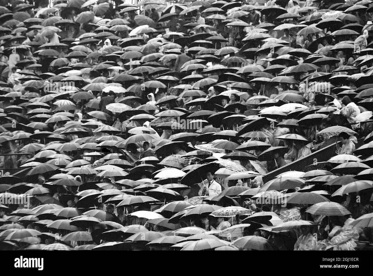 JEUX OLYMPIQUES, JEUX OLYMPIQUES DE SPORT - LA XVIII 18E OLYMPIADE À TOKYO, JAPON - PARASOLS DE STADE NATIONAUX VUS SOUS DE FORTES PLUIES ; 21 OCTOBRE 1964 Banque D'Images