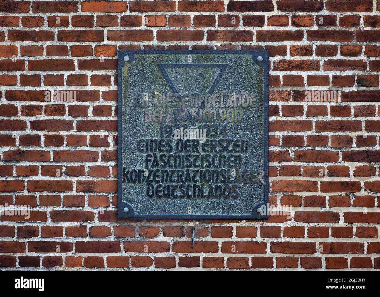 08 septembre 2021, Brandebourg, Oranienburg: Une plaque portant l'inscription 'l'un des premiers camps de concentration fasciste d'Allemagne a été situé sur ce site de 1933 à 1934' est apposée sur un mur de briques sur la Berliner Straße. En mars 1933, la sa locale avait établi le premier camp de concentration de Prusse dans l'ancienne brasserie Kindl. Jusqu'à la fermeture du camp en juillet 1934, environ 3000 prisonniers d'Oranienburg et des environs ainsi que de Berlin ont été internés ici. Au moins 16 des prisonniers sont morts dans le camp de concentration d'Oranienburg, dont l'écrivain Erich Mühsam. Le site commémoratif est Banque D'Images