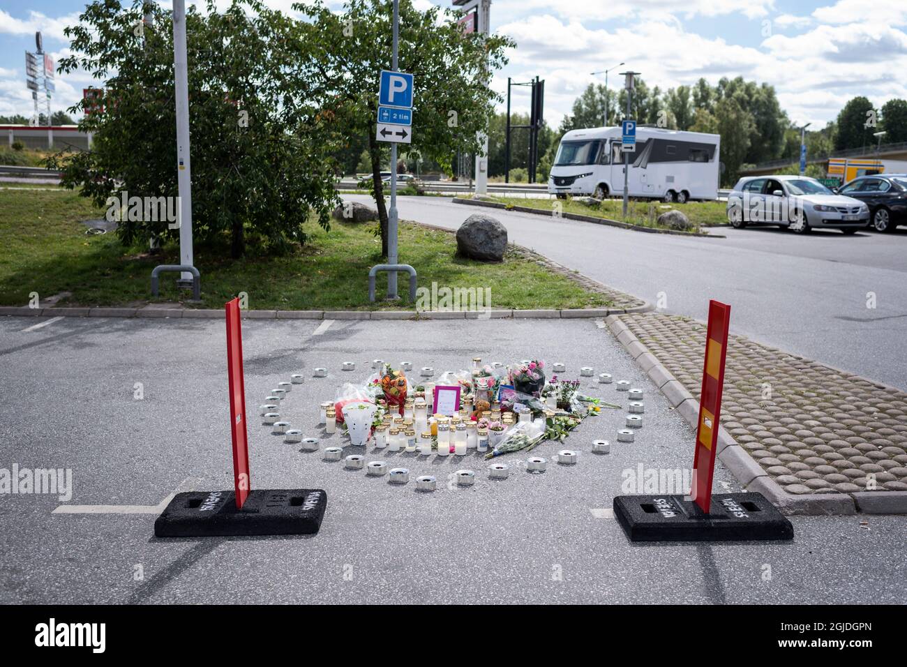 Fleurs et bougies sur le site où une jeune fille de 12 ans a été tuée par une balle perdue lors d'un trajet en voiture, en tirant sur une station-service de Norsborg, Botkyrka, au sud de Stockholm, le 03 août 2020. Ce meurtre a été décrit comme une fusillade de groupe. Photo: Stina Stjernkvist / TT code 11610 Banque D'Images