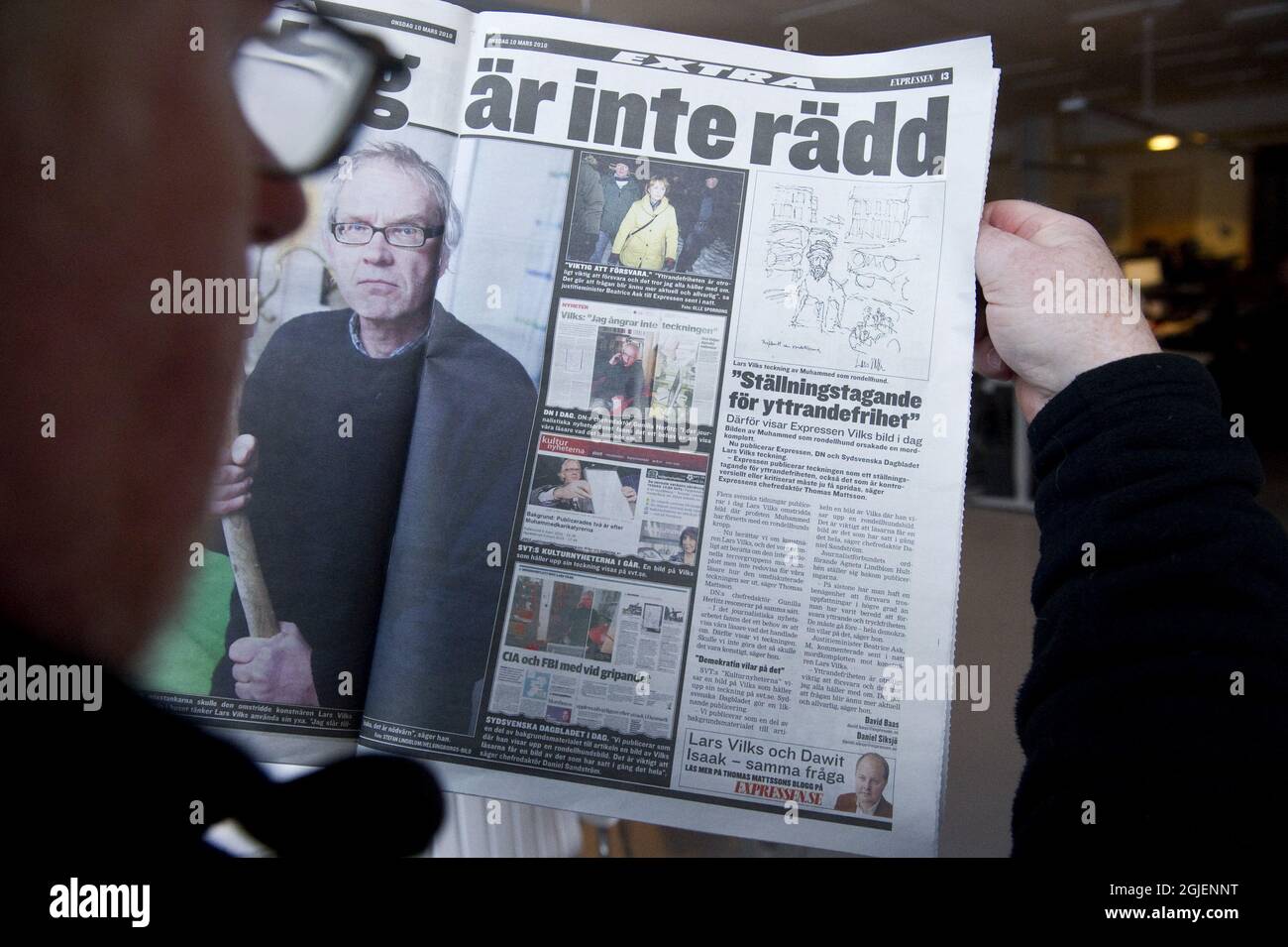 Un homme lit le numéro d'aujourd'hui de l'article du journal suédois Expressen sur la tentative de meurtre de l'artiste suédois Lars Vilks et le dessin représentant le prophète Mohammad avec le corps d'un chien. Banque D'Images