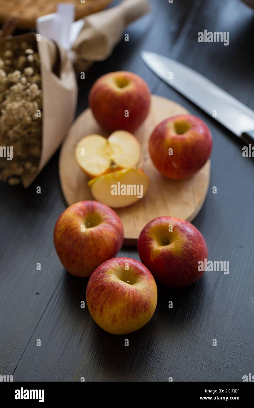 Pommes rouges sur fond de table en bois noir. Encore la vie. Banque D'Images