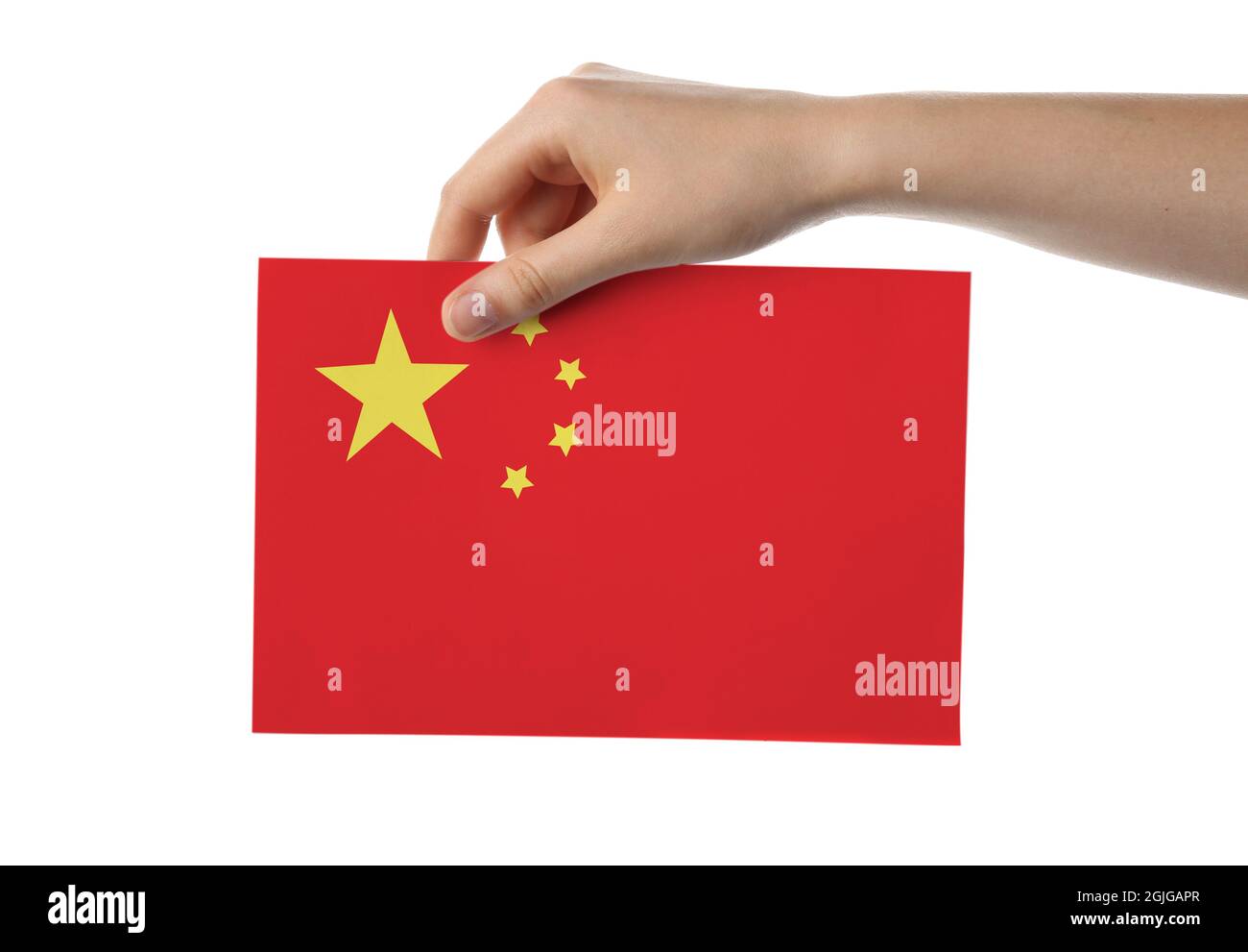 Main féminine avec drapeau chinois en papier sur fond blanc Banque D'Images