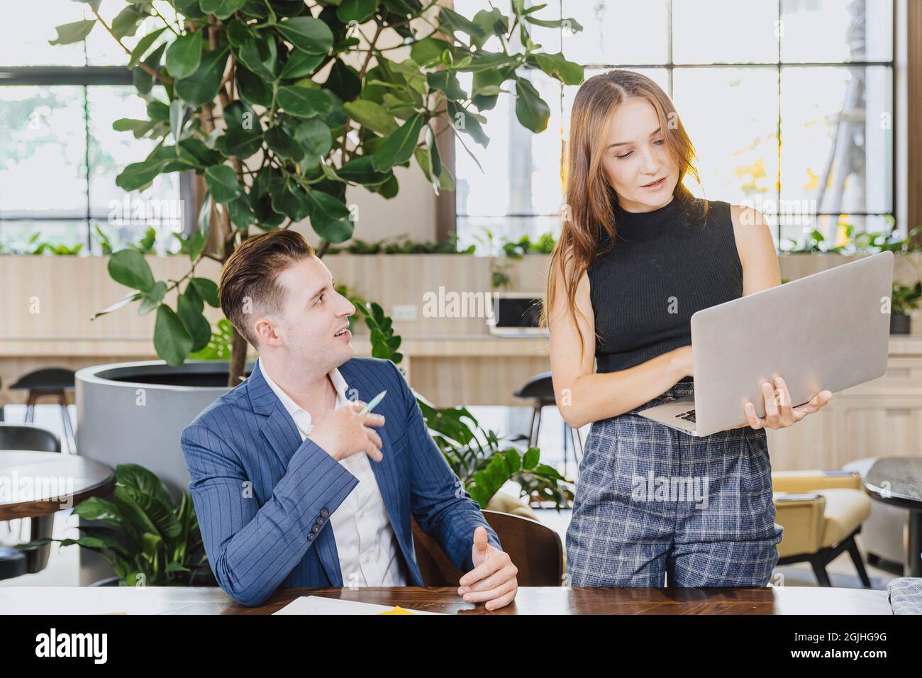 femmes actives fille intelligente responsable de travail avec hommes travail d'équipe discussion ensemble travail dans ordinateur portable dans le bureau moderne. Banque D'Images