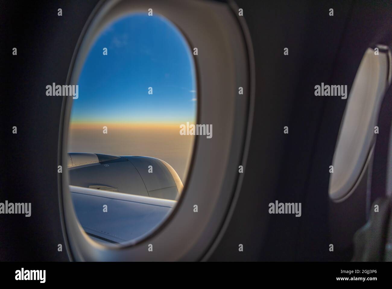 Vue sur le lever du soleil depuis un avion à fenêtre Banque D'Images