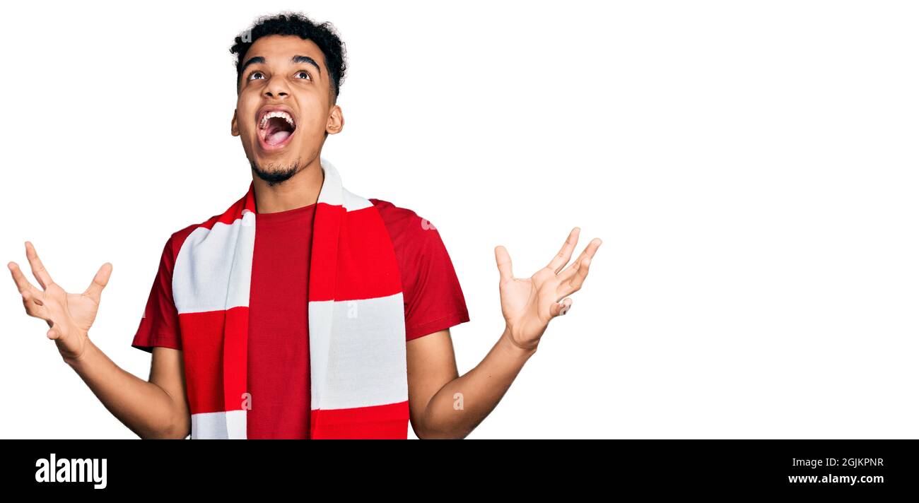 Jeune africain américain homme football hooligan jeu de acclamations fou et fou criant et hurlant avec l'expression agressive et les bras levés. Frustration Banque D'Images