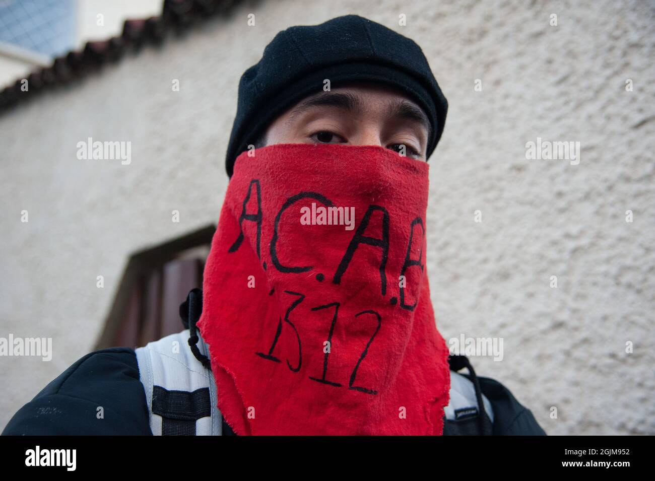 Bogota, Colombie. 10 septembre 2021. Un manifestant couvre son visage avec  un foulard rouge qui lit l'acronyme 'A.C.A.B 1312' au poste de police de  Villa Luz CAI ont été des policiers torturés