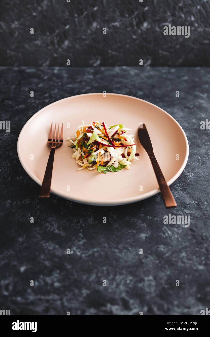 grande assiette avec une petite quantité de salade au centre, concept de  régime et restrictions caloriques Photo Stock - Alamy