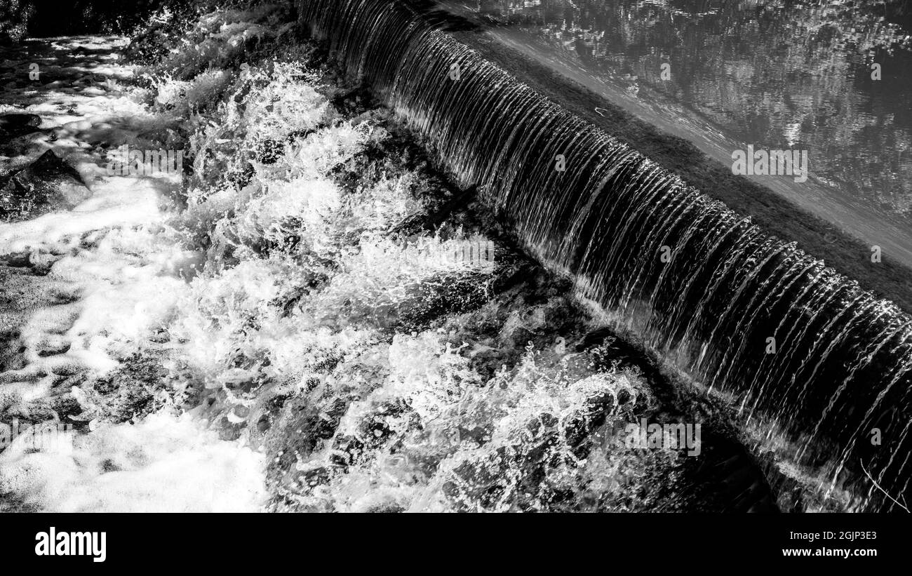 Petite cascade sur le ruisseau de la forêt. Sluice en pierre de Gaden dans une ambiance de forêt tranquille. Image en noir et blanc. Banque D'Images