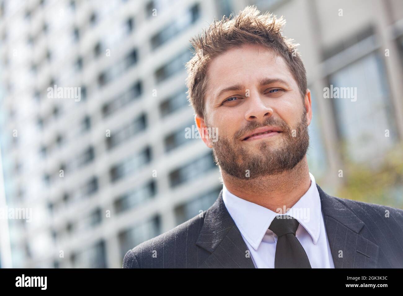 Jeune homme d'affaires avec succès, homme d'affaires avec cravate et  costume, devant un immeuble de bureaux de grande taille dans une ville  moderne Photo Stock - Alamy
