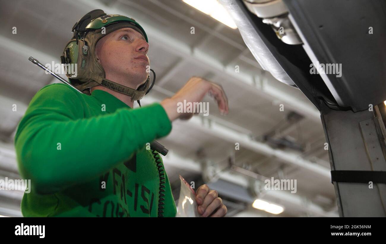 210804-N-ON253-1025 OCÉAN PACIFIQUE (AOÛT 4, 2021) technicien en électronique aéronautique 3e classe Kevin Benson, de Binghamton (N.Y.), remplace les rivets d'un F/A-18e Super Hornet, affecté aux « vigilantes » du Strike Fighter Squadron (VFA) 151 dans la baie hangar du porte-avions USS Abraham Lincoln (CVN 72). Abraham Lincoln mène actuellement des opérations de routine dans la zone d'exploitation de la 3e flotte américaine. Banque D'Images