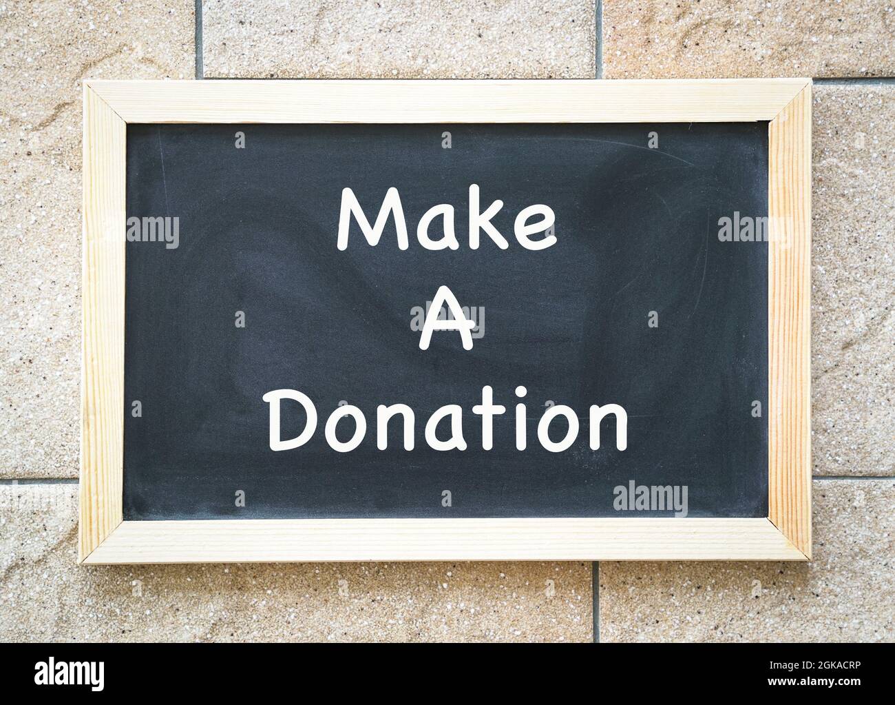 Tableau noir avec message, faire un don. Concept de charité. Banque D'Images