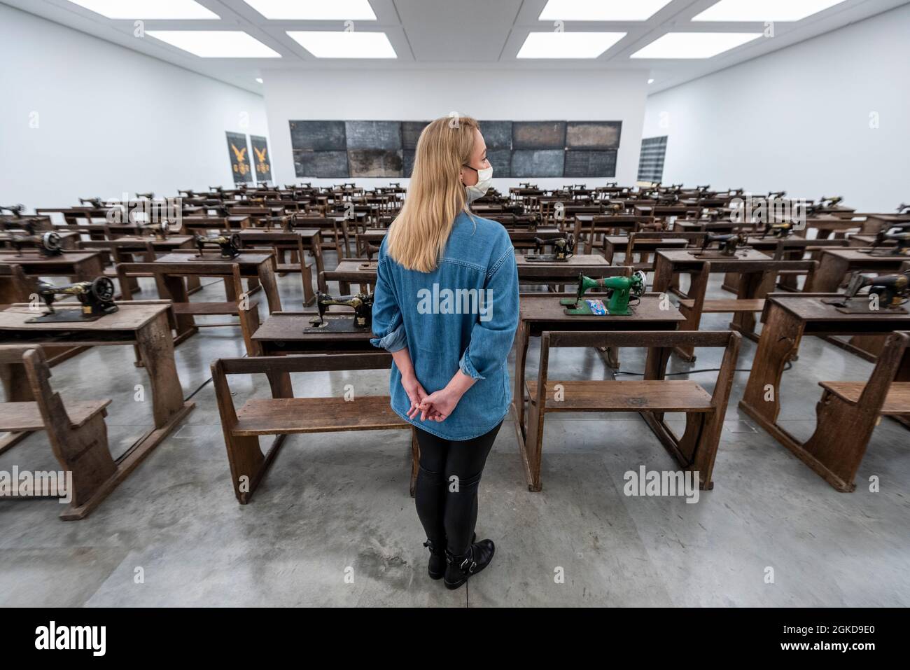 Londres, Royaume-Uni. 14 septembre 2021. Un membre du personnel voit Capital cadavres (2021) par Ibrahim Mahama, 100 machines à coudre en métal rouillé fixées aux bureaux d'école en bois. Aperçu de «Lazarus», la nouvelle exposition solo d’Ibrahim Mahama à la galerie White Cube de Bermondsey qui présente des installations à grande échelle, des sculptures et des collages. L'exposition est le résultat de plusieurs mois de recherche à Nkrumah Volini, dans le nord du Ghana, un silo en béton abandonné accueillant une grande colonie de chauves-souris qui a inspiré certains des travaux exposés. Le spectacle se déroulera du 15 septembre au 7 novembre 2021. Credit: Stephen Chung / Alamy Live News Banque D'Images Londres, Royaume-Uni. 14 septembre 2021. Un membre du personnel voit Capital cadavres (2021) par Ibrahim Mahama, 100 machines à coudre en métal rouillé fixées aux bureaux d'école en bois. Aperçu de «Lazarus», la nouvelle exposition solo d’Ibrahim Mahama à la galerie White Cube de Bermondsey qui présente des installations à grande échelle, des sculptures et des collages. L'exposition est le résultat de plusieurs mois de recherche à Nkrumah Volini, dans le nord du Ghana, un silo en béton abandonné accueillant une grande colonie de chauves-souris qui a inspiré certains des travaux exposés. Le spectacle se déroulera du 15 septembre au 7 novembre 2021. Credit: Stephen Chung / Alamy Live News Banque D'Images