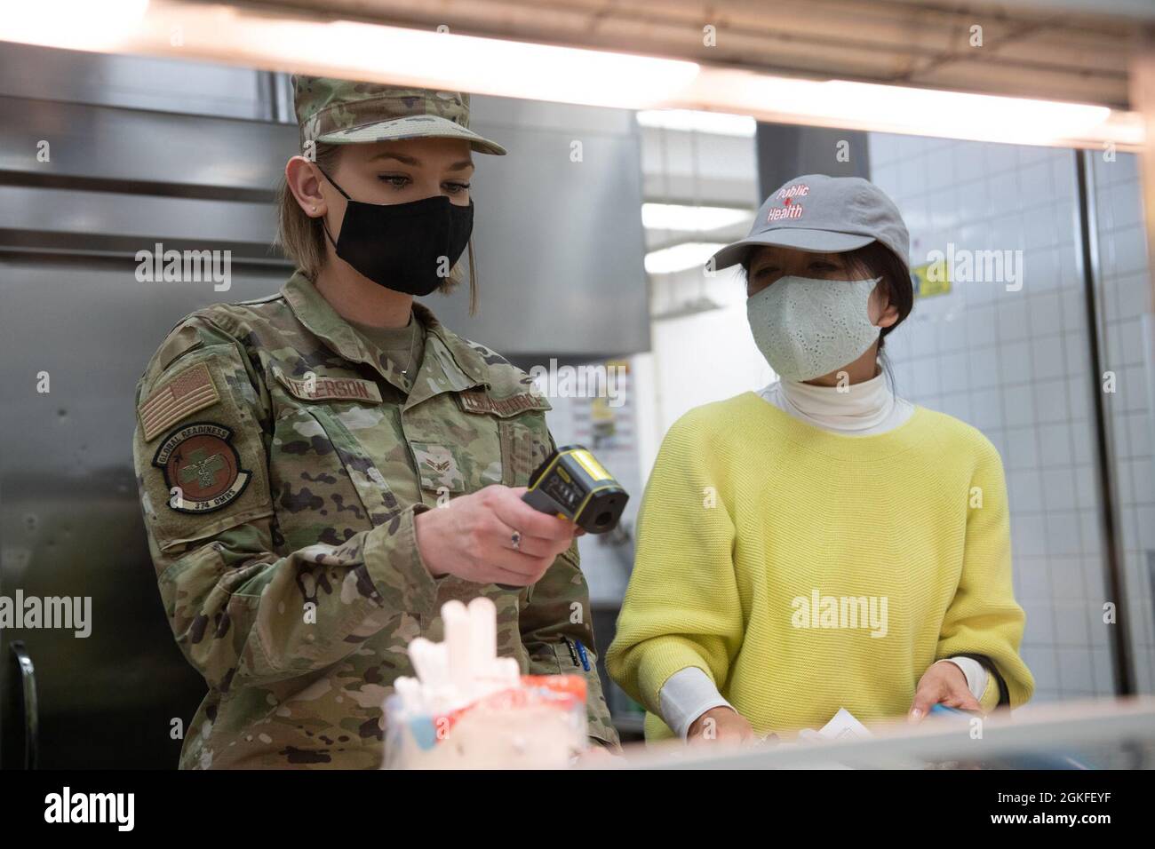 Airman 1re classe Emma Patterson, 374e Escadron de préparation médicale opérationnelle, technicien de santé publique, à gauche, et Hiroko Kitada, 374e technicien de formation de l'OMRS, balaie la température des aliments au Samouraï café Dining Facility, à la base aérienne de Yokota, au Japon, le 8 avril 2021. Les professionnels de la santé publique sont responsables d'effectuer des inspections de routine des aliments dans les restaurants de la base et de maintenir les normes de santé et de bien-être des clients. (Airman 1ère classe Tyrone Thomas) Banque D'Images