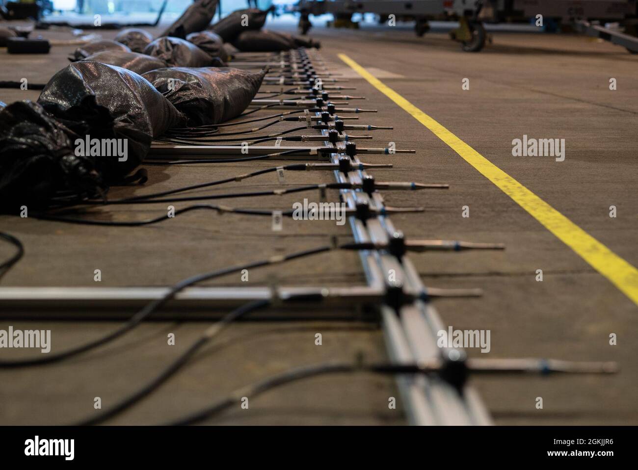 Des capteurs d'essai acoustique sont placés au sol d'un abri d'avion de protection avant un essai acoustique et d'émission F-35A Lightning II à Royal Air Force Lakenheath, Angleterre, le 4 mai 2021. Ces capteurs surveillent les niveaux acoustiques présents dans le logement lors des différentes étapes de fonctionnement du moteur. Banque D'Images