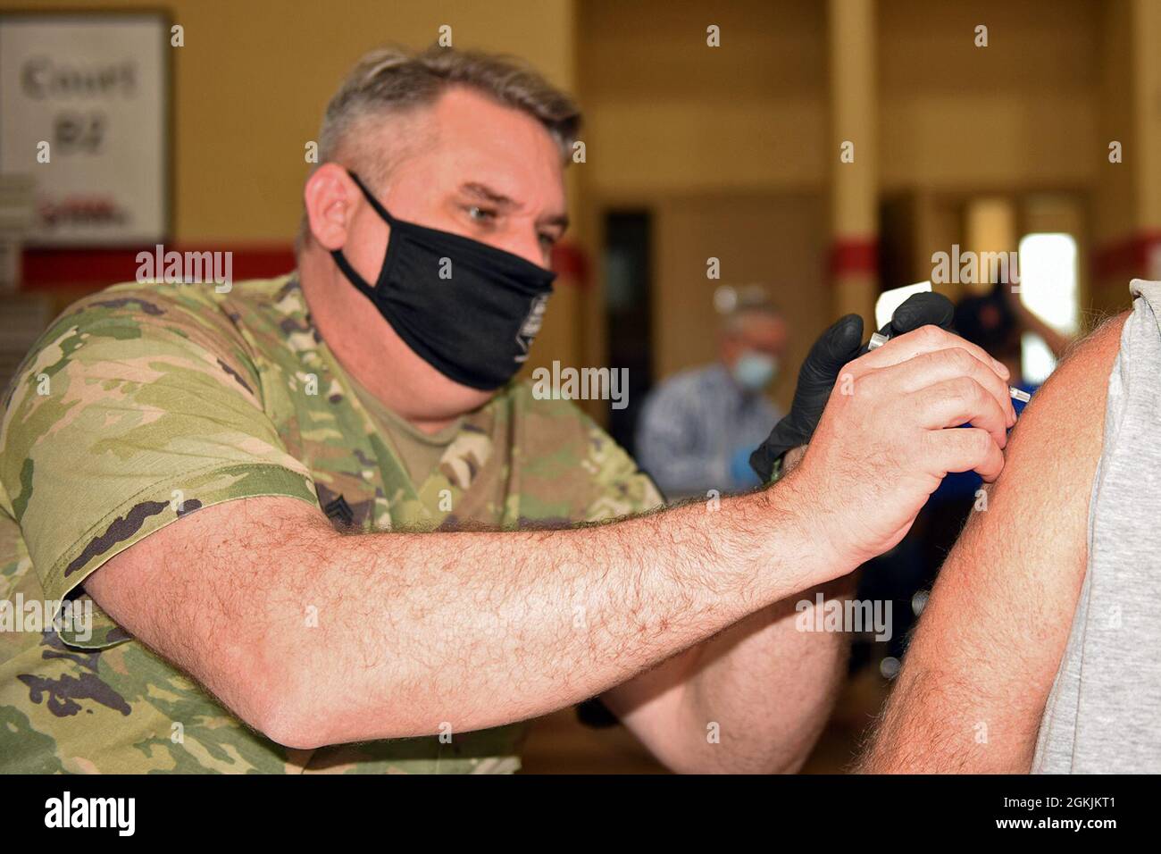 SPC de l'armée américaine. Justin Williams un medic de combat de la Garde nationale de l'armée du Michigan, qui travaille actuellement avec l'équipe de vaccination/test (CVTT) de la Force opérationnelle du Michigan Spartan COVID-19, administre la vaccination COVID-19 aux résidents locaux au cours d'une clinique de vaccination communautaire pour le département de santé du comté de Genesee à l'église centrale du Nazaréen, Flint, Michigan, 5 mai 2021. Les CVTT de la Garde nationale du Michigan augmentent les organismes de soins de santé locaux, comme demandé, dans la prestation et l'administration de la vaccination aux Michiganders. Banque D'Images