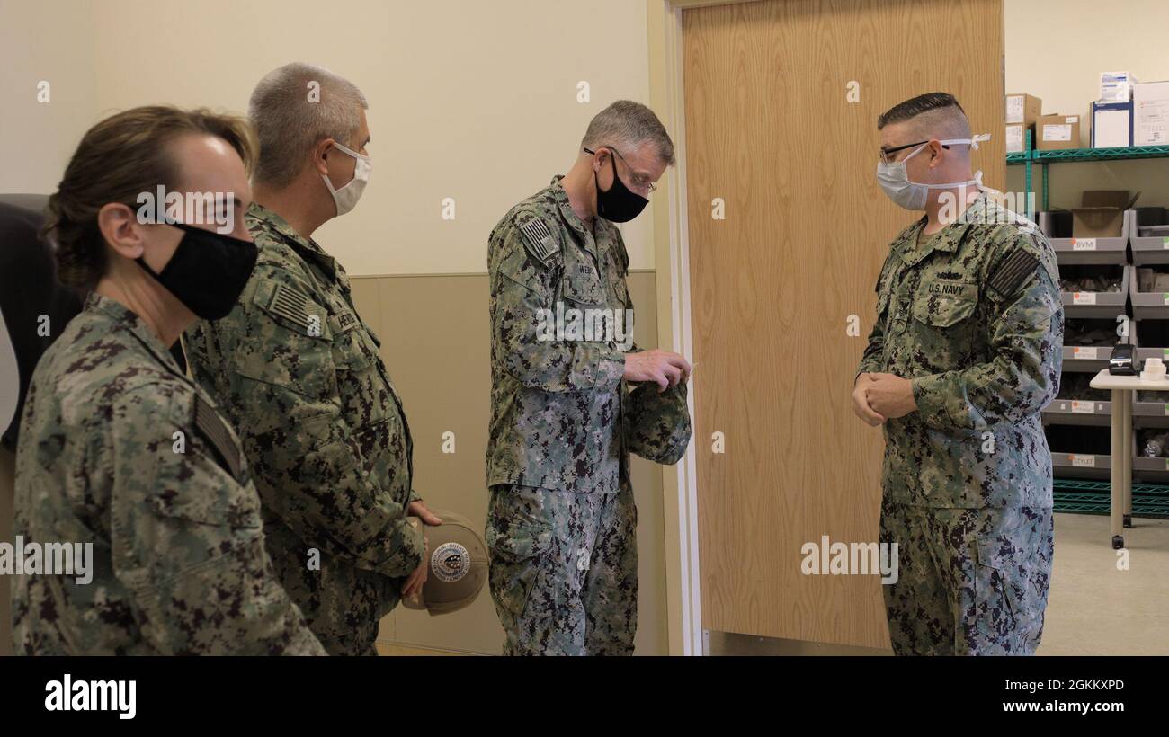 Hôpital Corpsman 1ère classe Phillip Tinker présente le sous-ministre. Tim Weber, commandant des Forces médicales navales du Pacifique et directeur du corps des services médicaux de la Marine, avec une pièce de monnaie après lui avoir offert une visite des espaces de formation en thérapie respiratoire au Campus d'éducation et de formation médicales, au cours d'une visite, le 19 mai. Le METC est un campus à trois services qui offre 48 programmes d'enseignement différents aux élèves du DoD, y compris l'hôpital Corpsman Basic, également connu sous le nom d'école « A ». Weber, qui a la supervision des huit laboratoires de recherche médicale de la Marine Medicine, était dans l'État de Lone Star pour assister à la Naval Medical Resea Banque D'Images