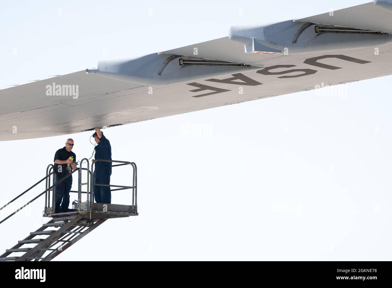 Frederick David, à droite, spécialiste du système de contrôle de vol intégré du 60e Escadron de maintenance des aéronefs, et Jeffrey Leonard, électricien du 60e AMM, inspectent les fentes d'une aile Super Galaxy C-5M le 4 juin 2021, à la base aérienne de Travis, en Californie. Le C-5 est le plus grand avion de l'inventaire de la Force aérienne et a une envergure de 222 pieds et 9 pouces. Banque D'Images