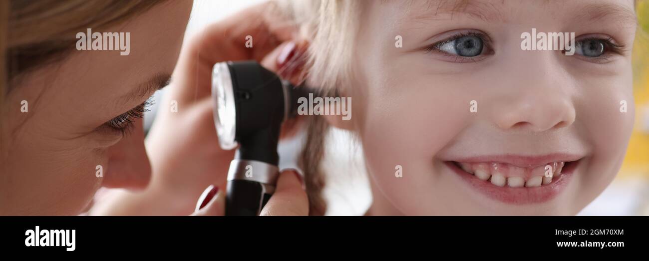 ORL médecin examinant l'oreille douloureuse du petit enfant à l'aide d'un otoscope Banque D'Images
