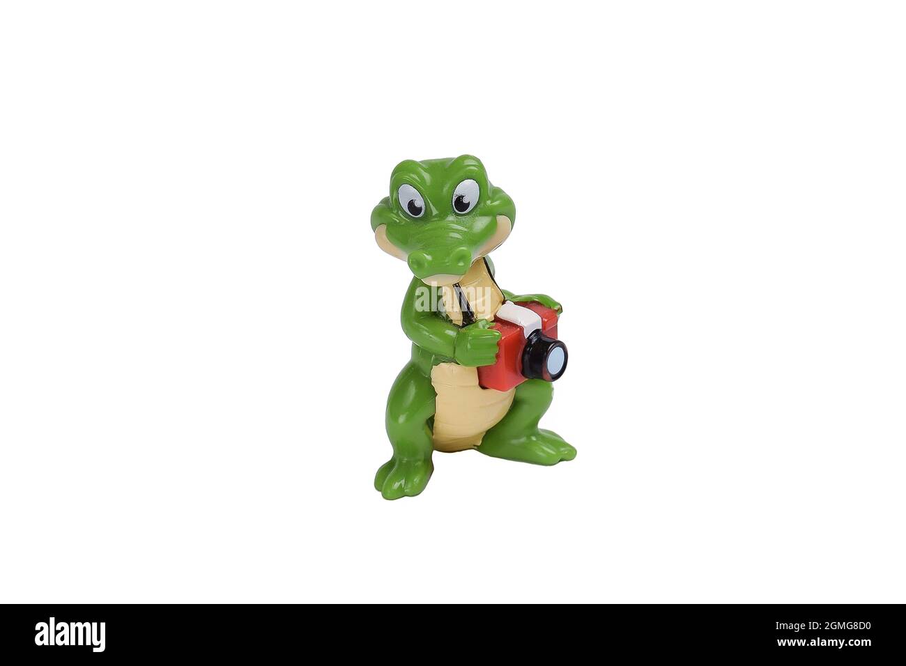Figurine crocodile de dessin animé jouet avec un appareil photo sur fond blanc sous la coupure Banque D'Images