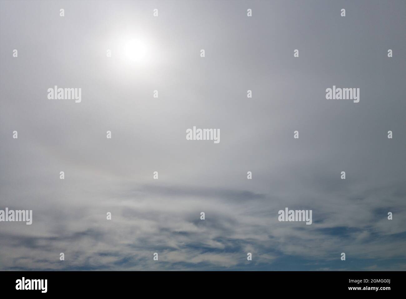Le soleil à travers des nuages brumeux. Banque D'Images