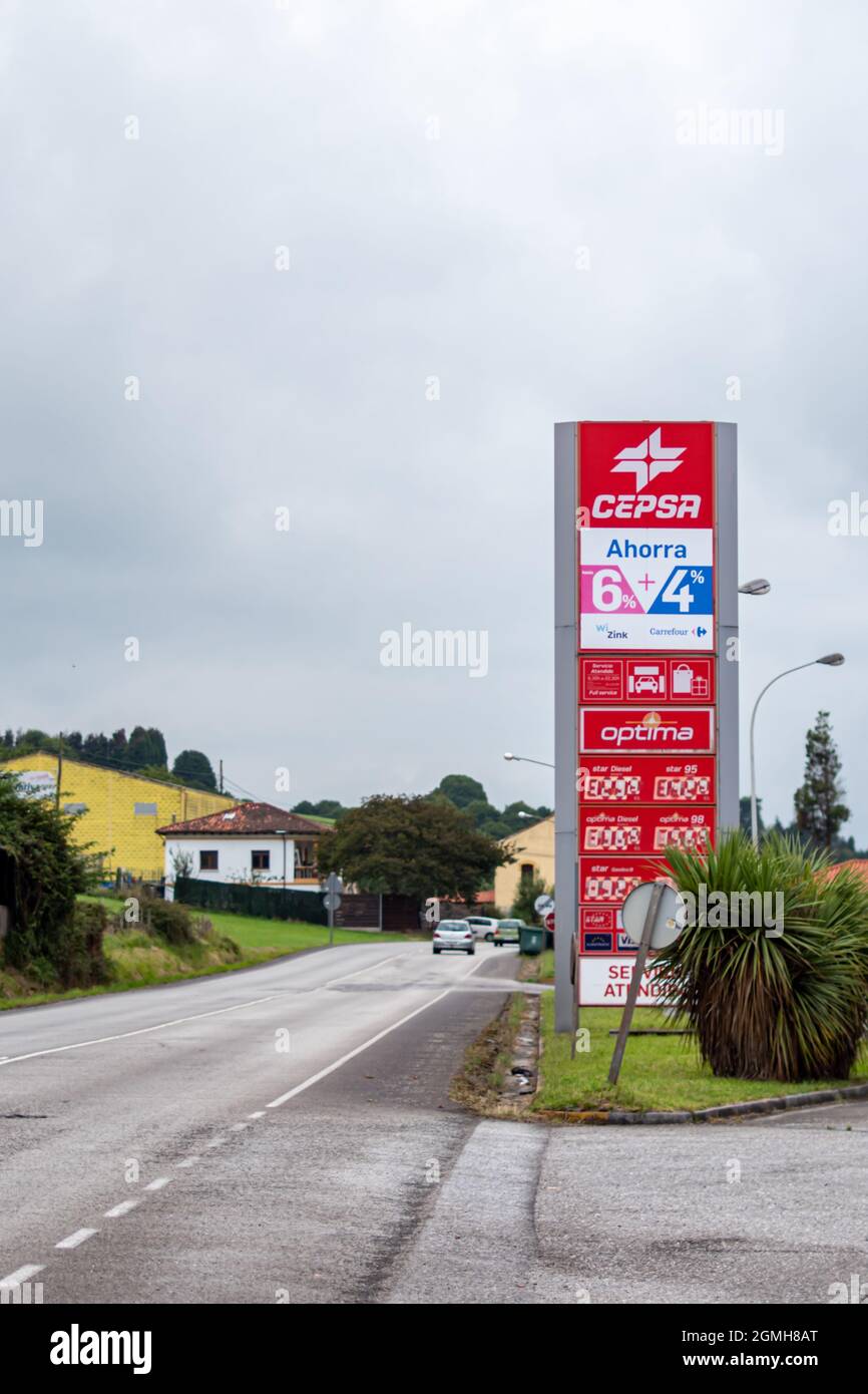 GIJON, ESPAGNE - 27 août 2021 : un cliché vertical du panneau d'affichage de la marque Cepsa sur pelouse par route le jour sombre de Gijon, Espagne Banque D'Images