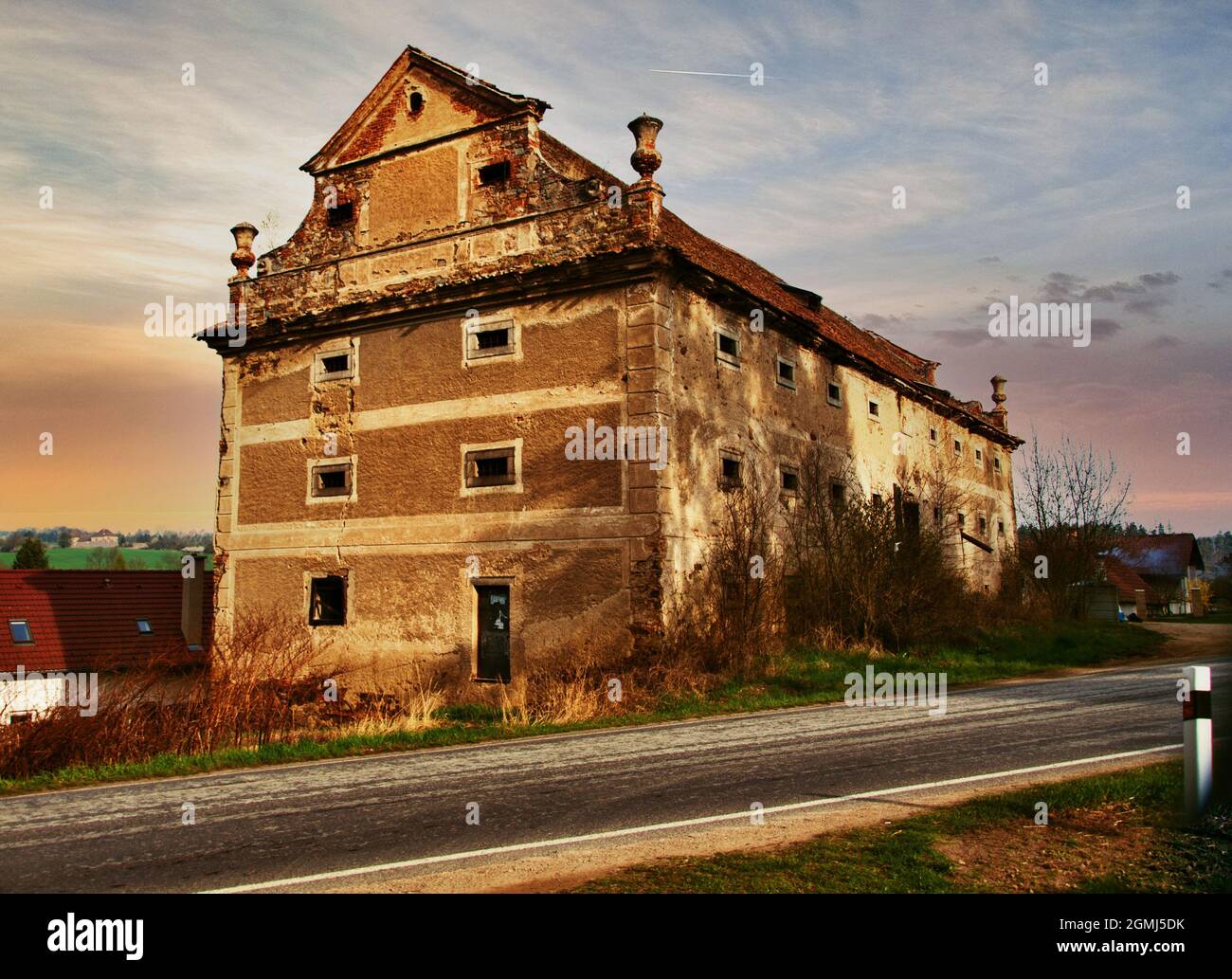 Ancien bâtiment de granary baroque délabré datant du 18. Siècle dans le village Kolodeje nad Luznici, dans un bel éclairage de lever de soleil. République tchèque. Banque D'Images