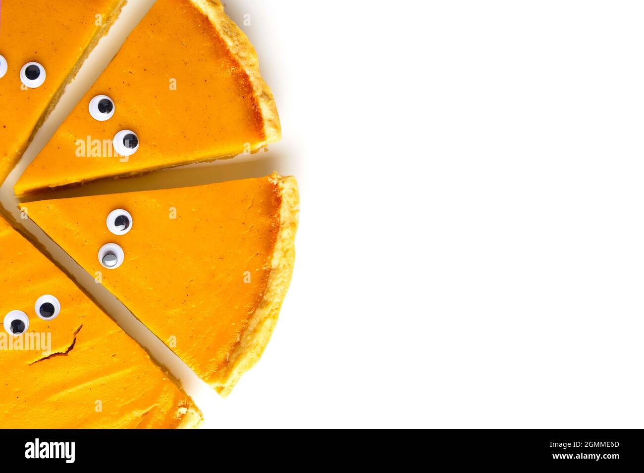 Tranches de tarte à la citrouille sous forme de fantôme d'Halloween avec les yeux sur fond blanc isolé avec espace de copie. Concept gastronomique créatif pour les fêtes Banque D'Images