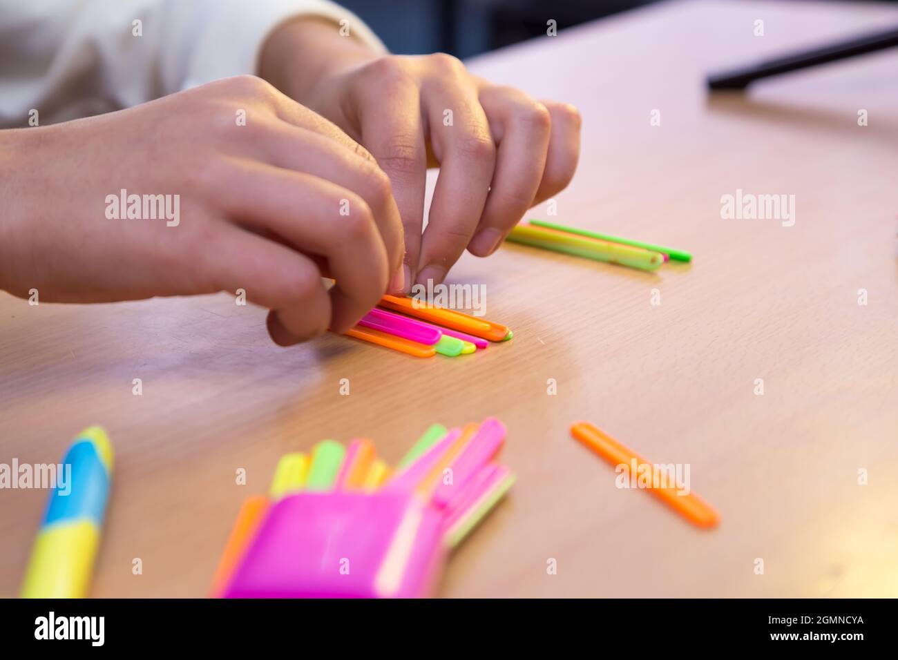 Les mains des élèves en gros plan sont comptées avec des bâtons mathématiques. Un écolier effectue une tâche sur le lieu de travail. Le concept de l'éducation, de l'enseignement des connaissances, des compétences et des capacités des enfants. Banque D'Images