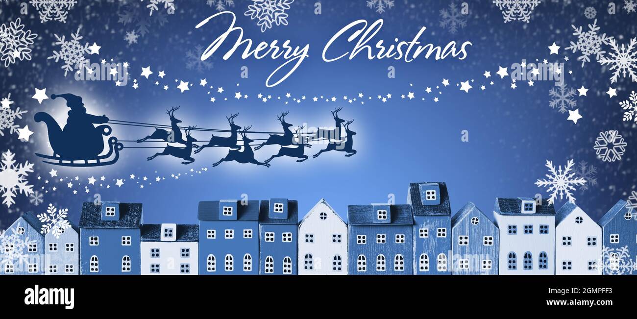 Bannière de Noël - le Père Noël en traîneau et en traîneau à rennes survole les maisons de la ville Banque D'Images