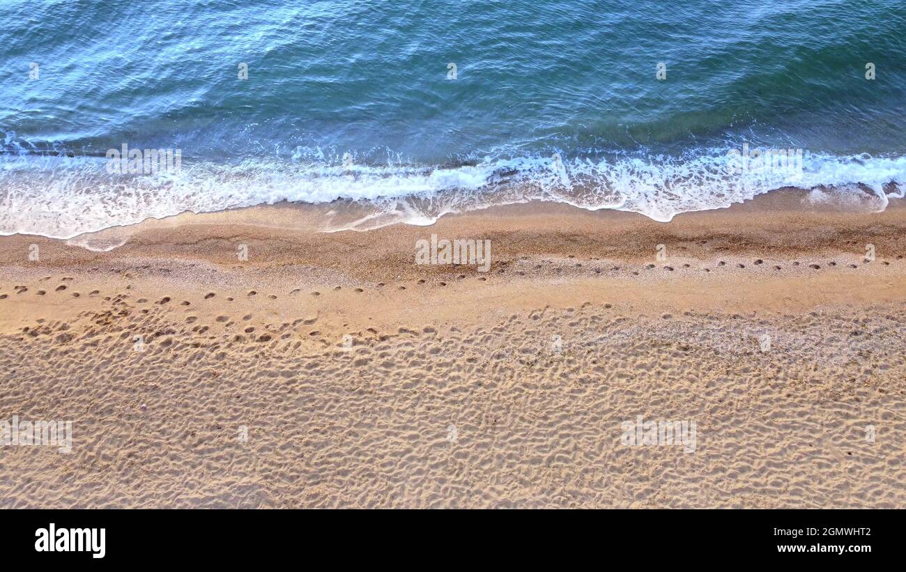Vue sur les vagues de la plage. Sable jaune et eau bleue Banque D'Images