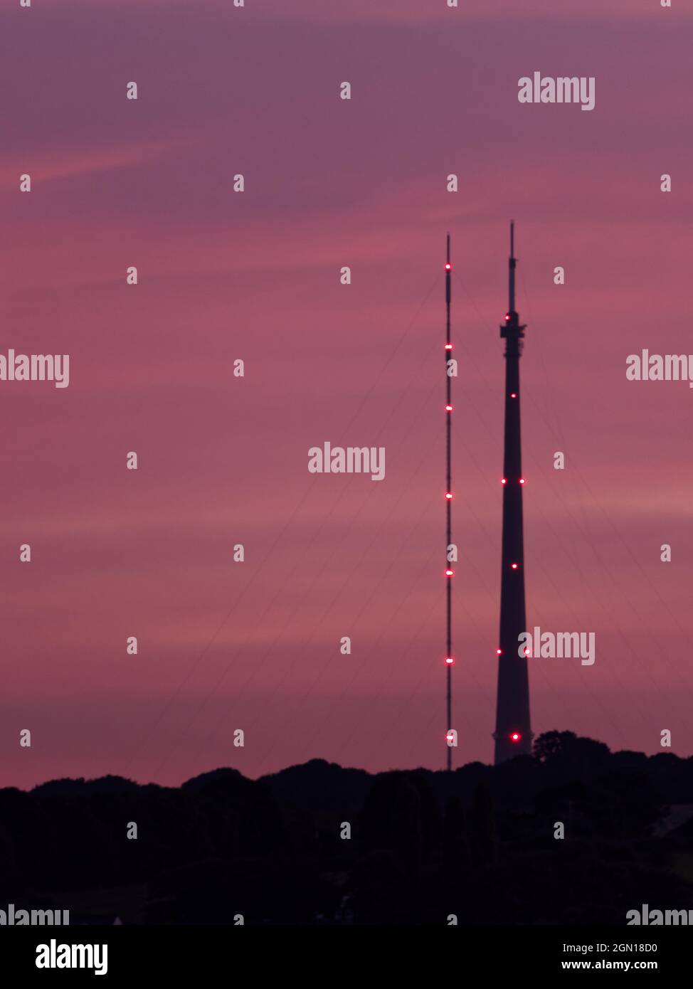Station de transmission Emley Moor, à Wakefield, dans le West Yorkshire, silhoueted contre un coucher de soleil violet. À gauche est la tour temporaire, à droite est l'Arqiva à Banque D'Images