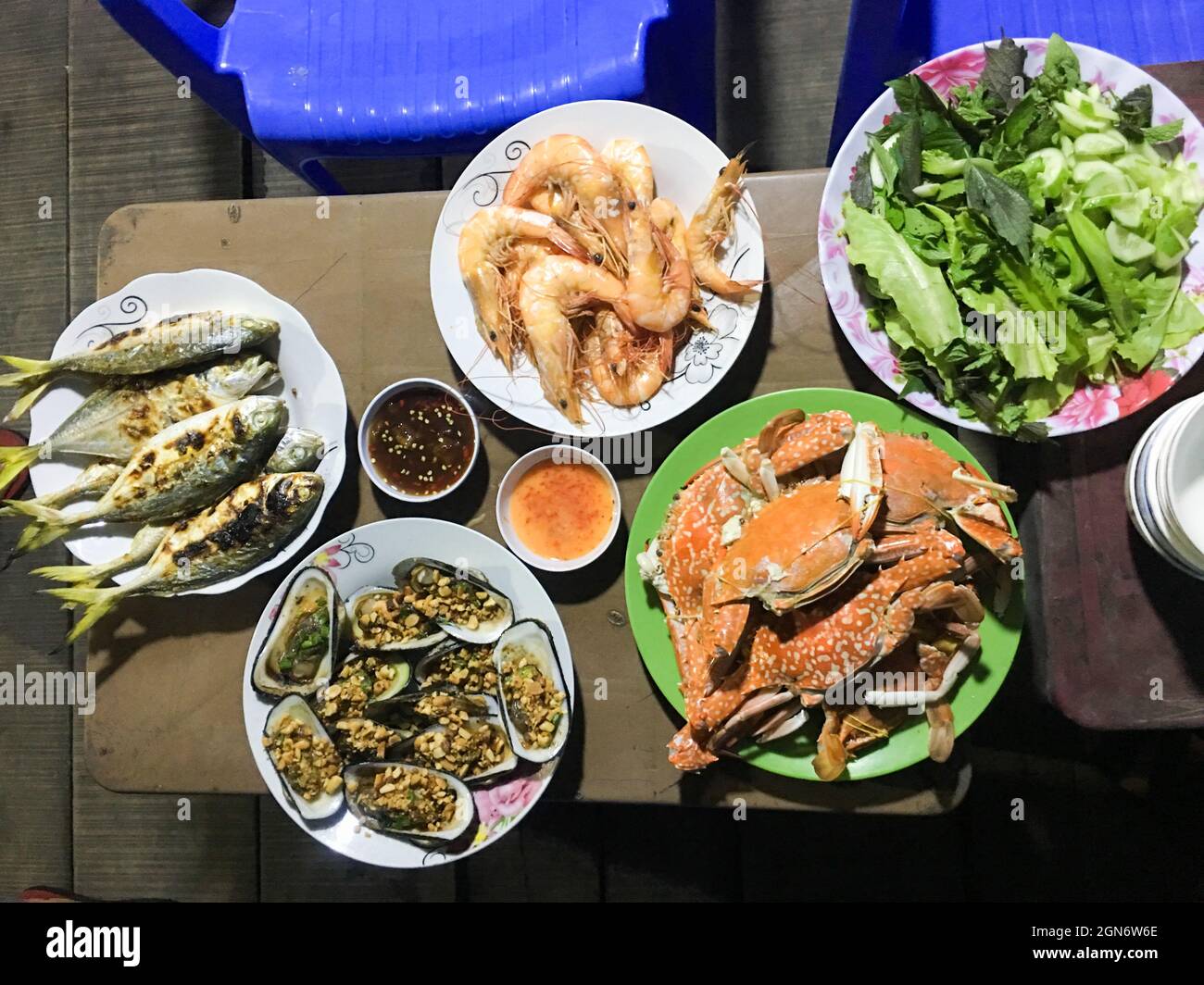 table à manger avec des légumes crus et des plats de fruits de mer tels que les crabes sentinelles, les crevettes, l'émail de vénus coquillage, les palourdes, le poisson Banque D'Images