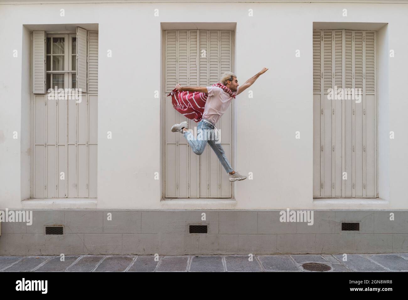 Un jeune homme sautant sur la piste comme super-héros Banque D'Images