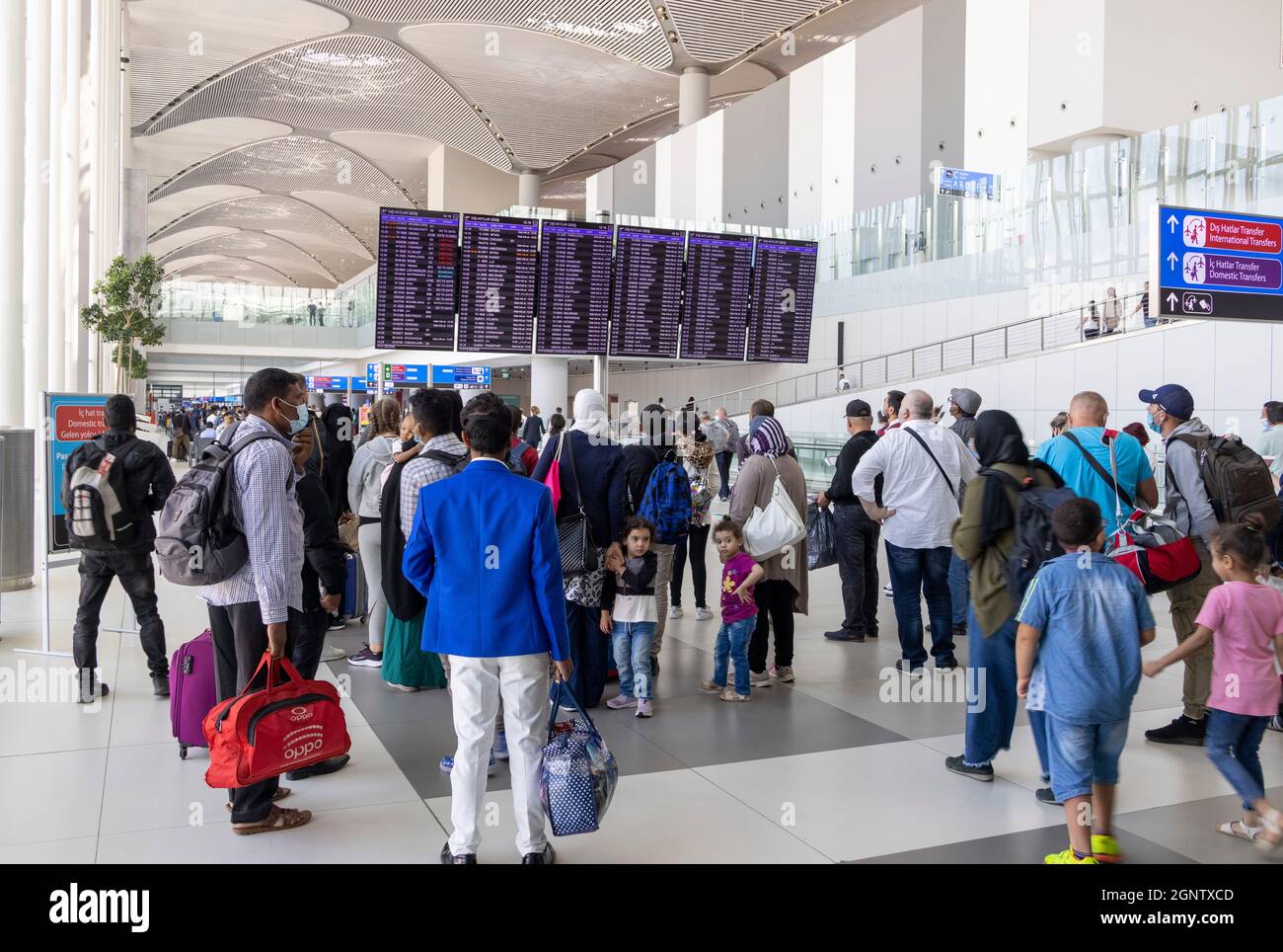 Passagers en transit regardant le panneau de départ, aéroport d'Istanbul. Turquie Banque D'Images