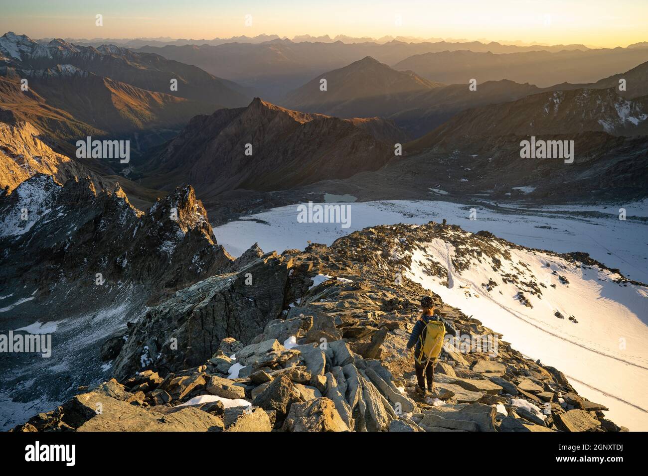 La femme est seule sur le pic du rock. Observation des randonneurs au soleil d'automne à l'horizon . Beau moment le miracle de la nature. Brume colorée dans la vallée. Banque D'Images