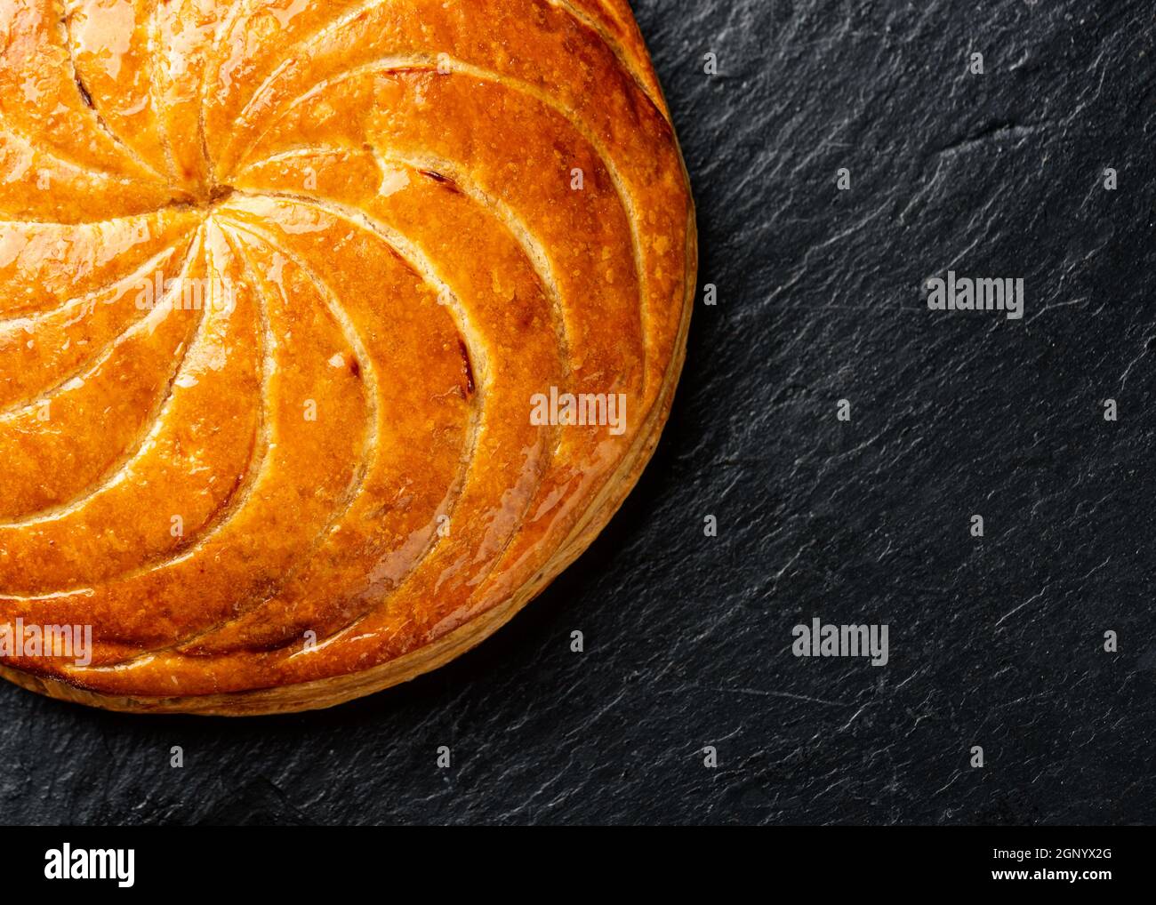 Epiphany cake ou galette des rois en français sur fond d'ardoise noire Banque D'Images
