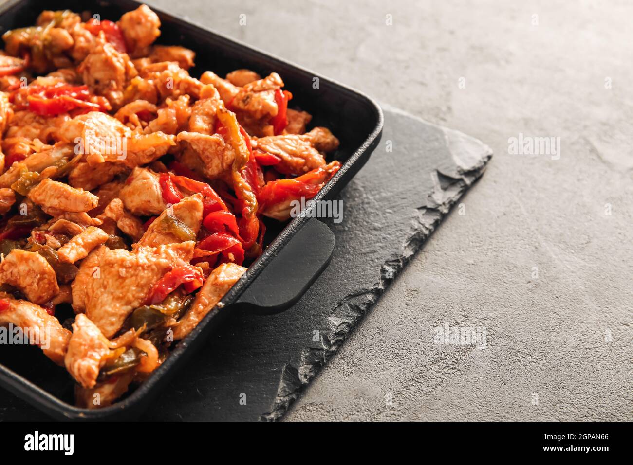 Poêle à frire avec poulet savoureux Fajita sur fond gris, gros plan Banque D'Images