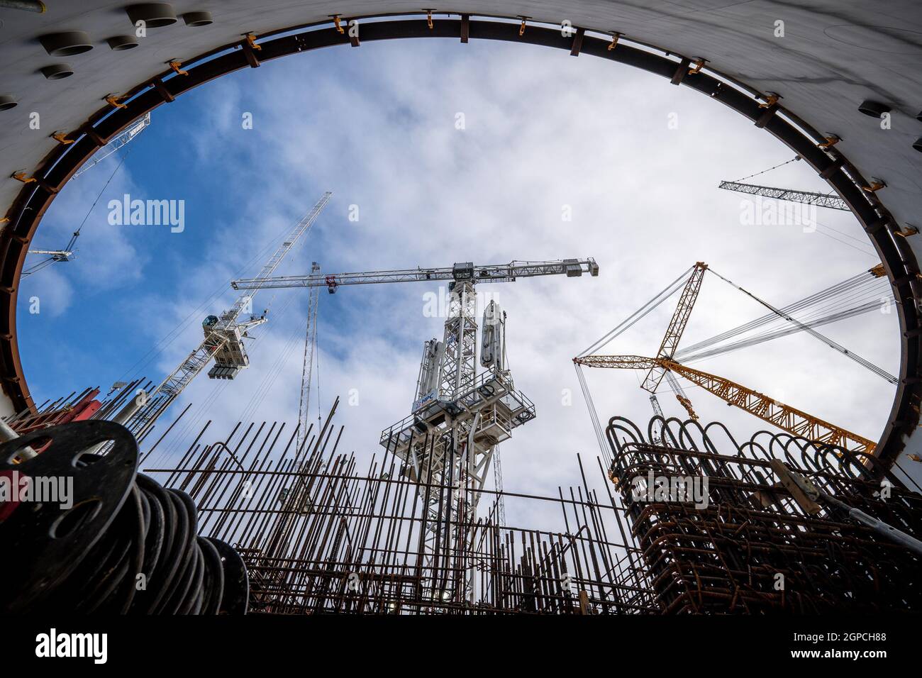 Une grue déplace les matériaux de construction dans la maison circulaire en béton armé et en acier d'un réacteur à Nuclear Island 1, à la centrale nucléaire de Hinkley point C près de Bridgwater, dans le Somerset, alors que les travaux sur le projet atteignent le cinq ans anniversaire. Cinq ans après avoir obtenu le feu vert, le nombre de personnes travaillant sur la centrale électrique de Hinkley point C a atteint 22,000. Le nombre croissant comprend 6,300 personnes sur place, comparativement à seulement 1,500 au plus fort de la pandémie l'an dernier. Date de la photo : jeudi 23 septembre 2021. Banque D'Images