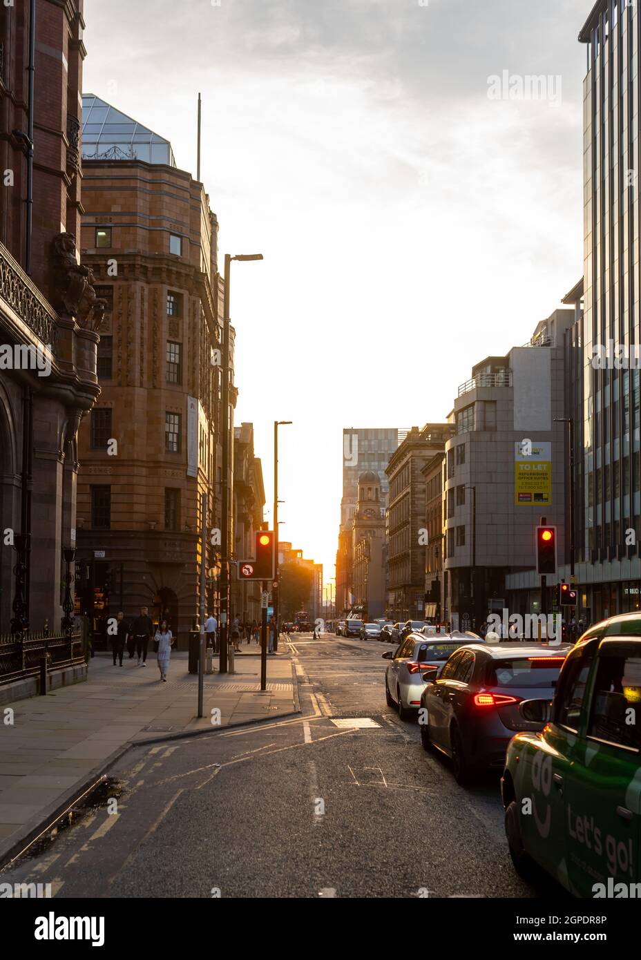 Manchester, Royaume-Uni 26.7.2021 - Golden hour coucher de soleil sur la route principale qui traverse le centre-ville de Manchester en soirée d'été. Banque D'Images