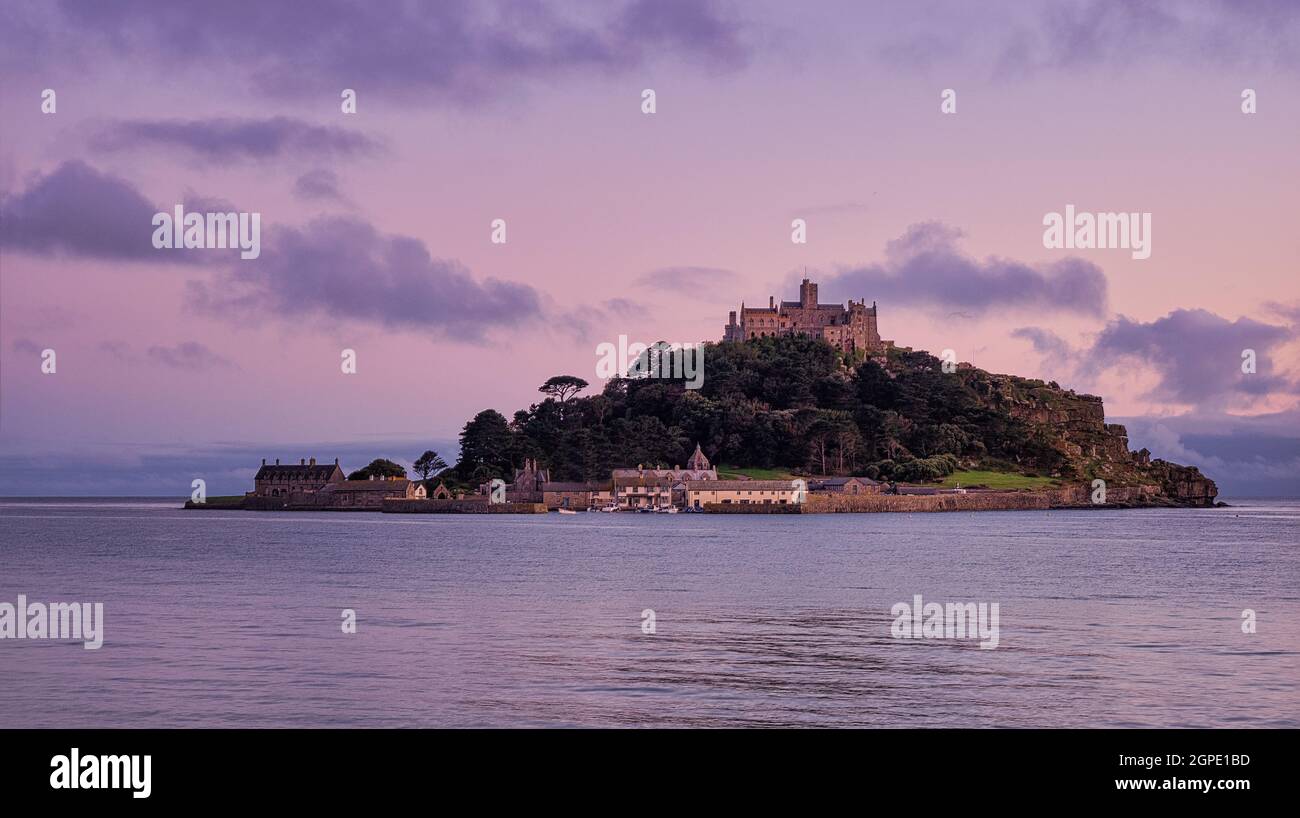 Doux ciel rose au coucher du soleil sur le mont St Michael's, une île marécageuse près de Marazion, en Cornouailles. Banque D'Images