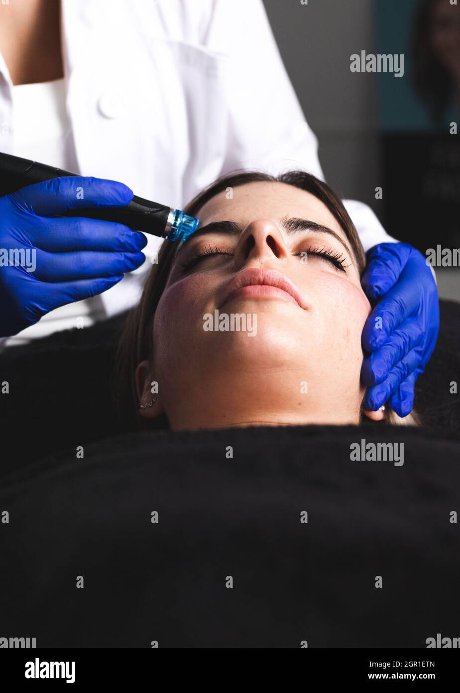 Une jeune femme nettoyant son visage dans une clinique esthétique Banque D'Images